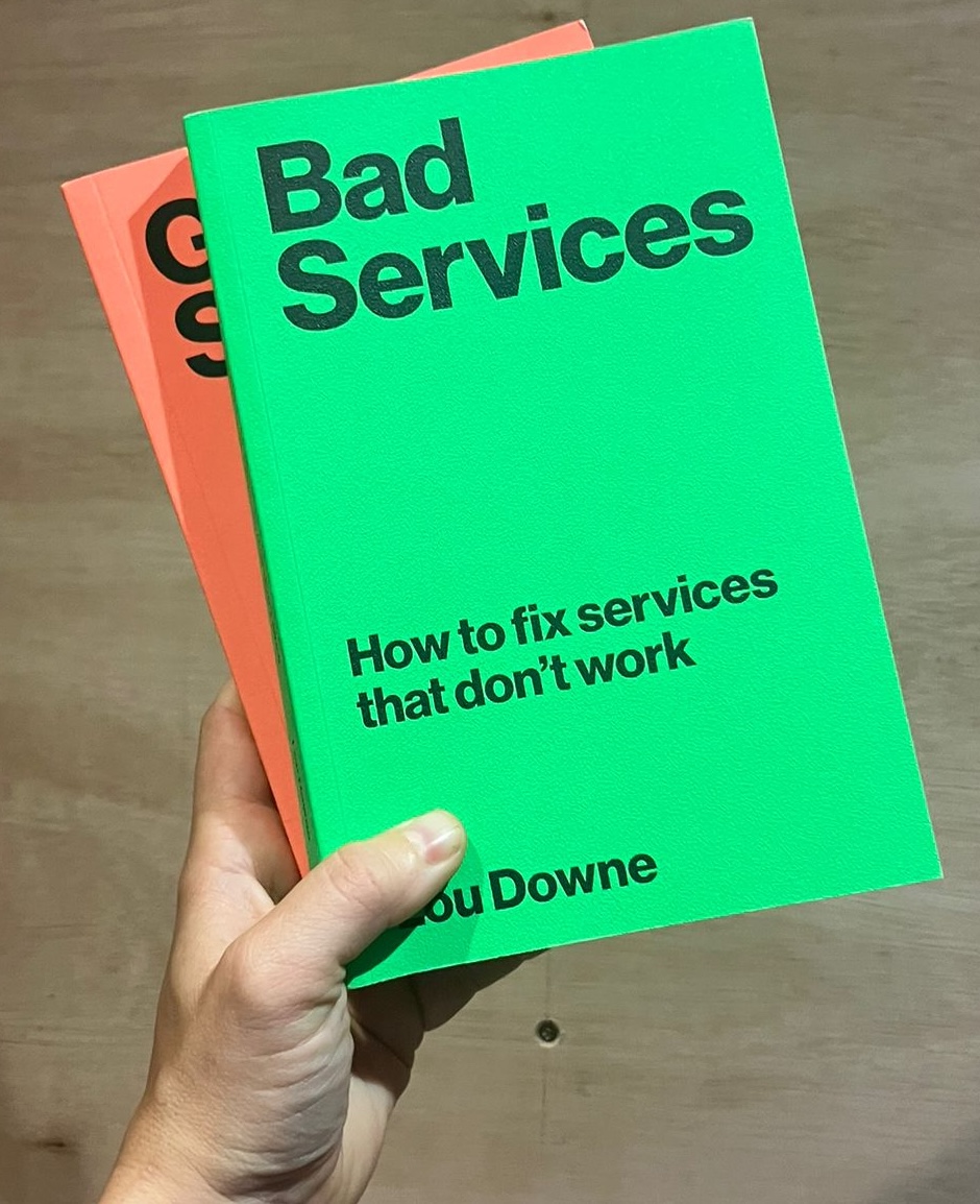 Bad Services and Good Services, held up against a plywood wall